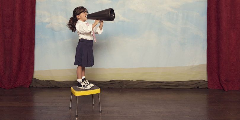 Young Business Girl Yells Through Megaphone